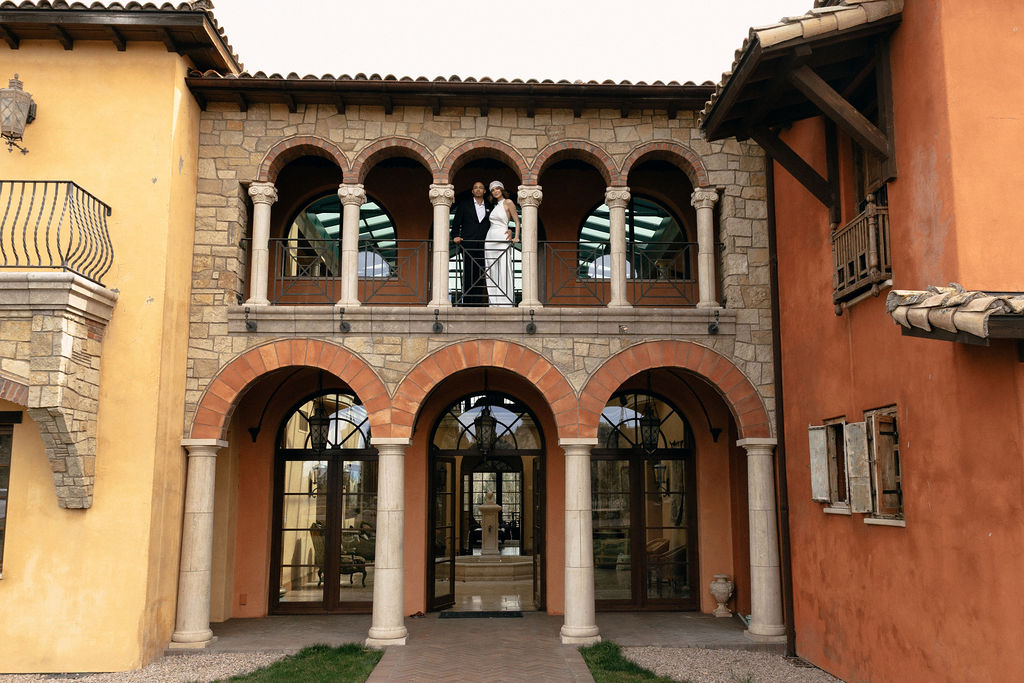 Couple stands on a balcony of The Old Winery Clubhouse at Ranch at the Canyons