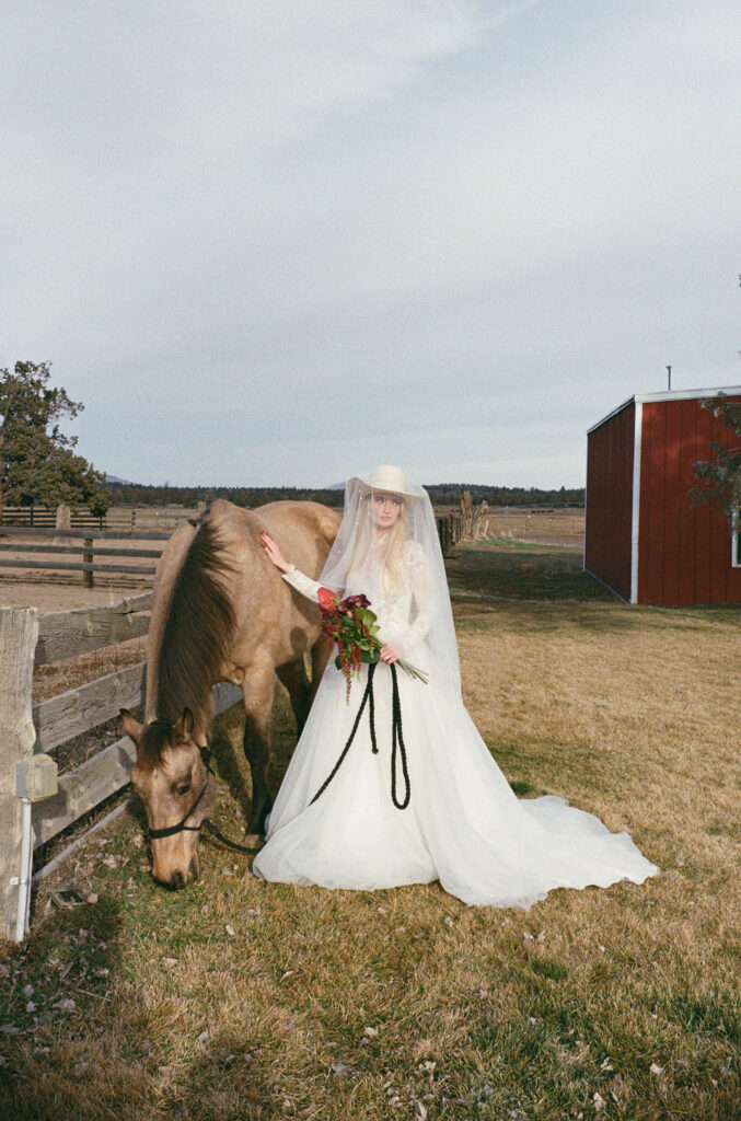 Bride stands with a horse at Long Hollow Ranch
