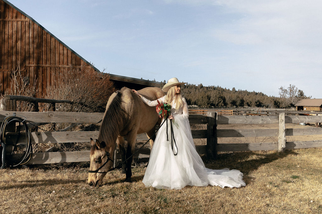Bride stands with a horse at Long Hollow Ranch