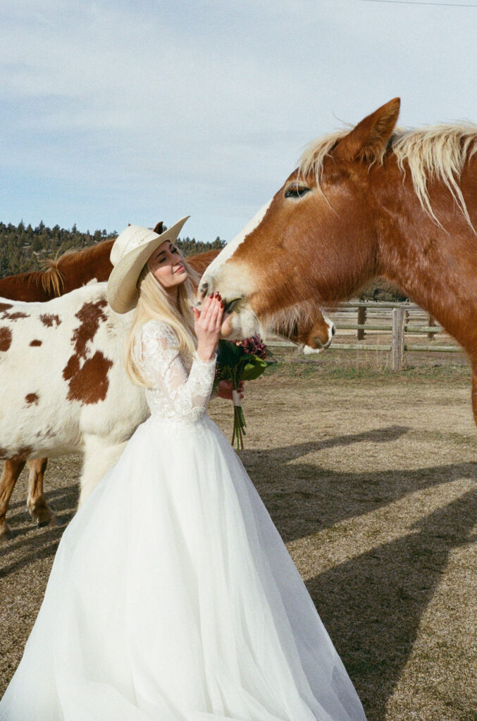 Bride stands with a horse at Long Hollow Ranch